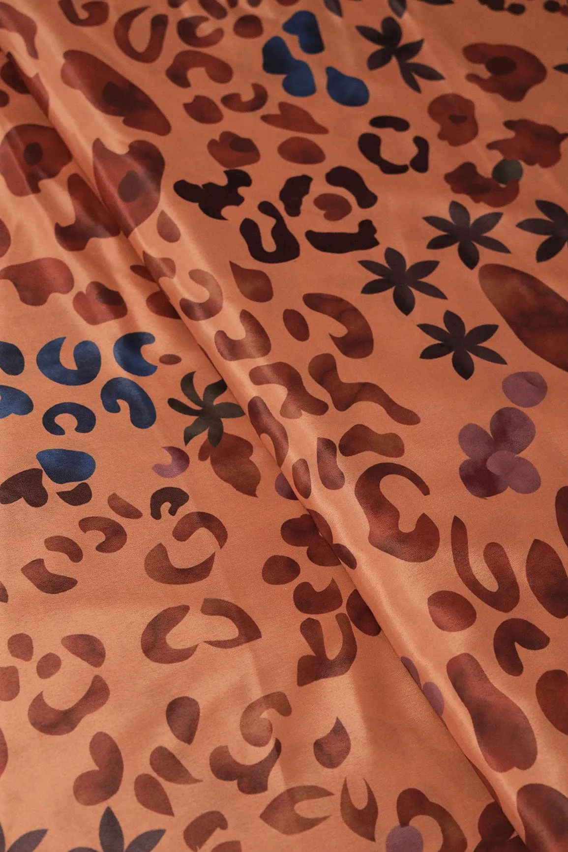 Brown And Blue Abstract Print On Pastel Orange Crepe Fabric